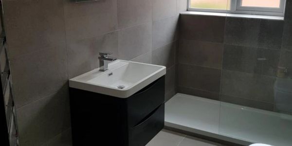 Fully installed bathroom with wall hanging basin, fitted in Derbyshire 