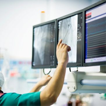 Cardiologist pointing to EKG of heart