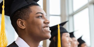 Smiling students at high school graduation.