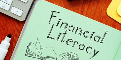 A notebook titled financial literacy to signify enrichment programs.