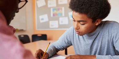 A Permission to Succeed Education Center working on on one with a teacher.