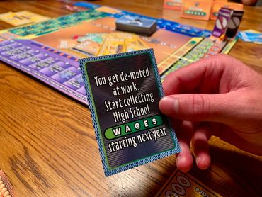 Strike It RIch board game reading a draw card.