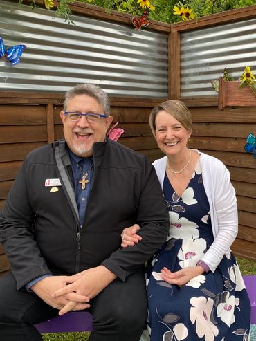 couple sitting on bench smiling