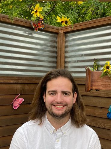 man sitting and smiling for photo