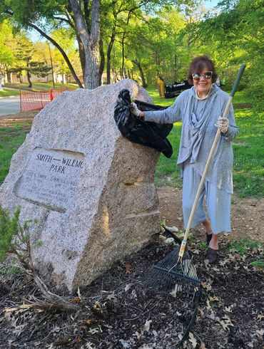 Peggy Terrell tends the plants around the Smith-Wilemon sign.