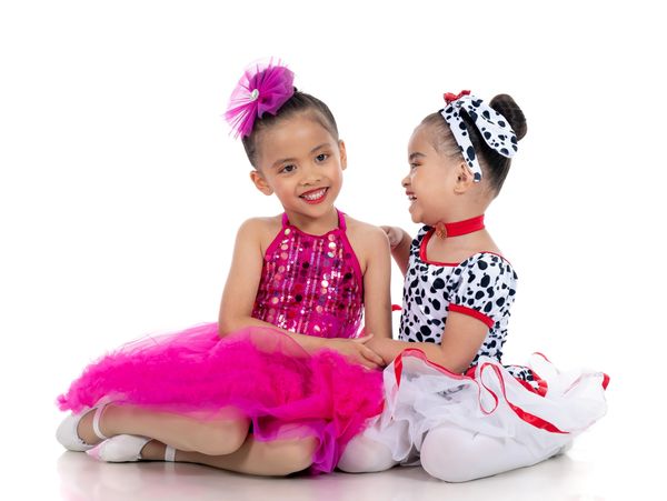 Two girls sitting on the stage and looking ahead