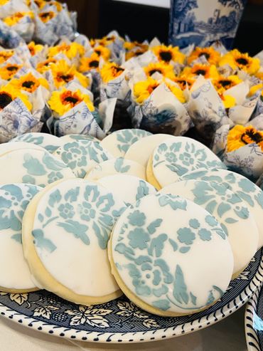 Hand drawn floral in blue cookies with sunflower cupcakes.