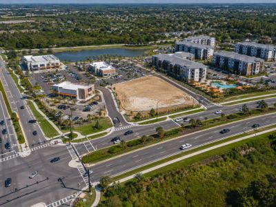 Aerial view of a mixed-use development, site access, and surrounding roadway network