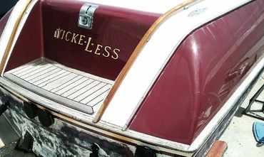 The back of a boat with the word 'RECKLESS' on the side.