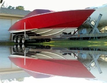 A red boat reflected in the water.