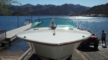 The front of a white boat on a trailer.