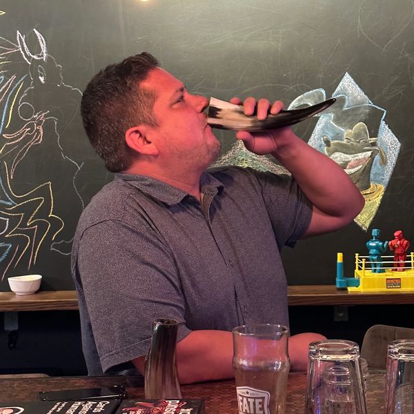 Guest drinking mead from a mead horn