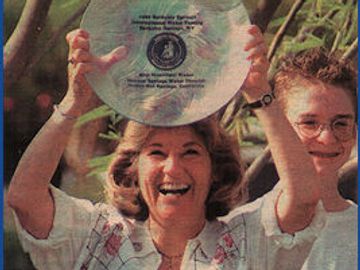 Nancy Wright enthusiastically raises a winning water award. 
