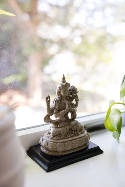 Small Buddha statue on a windowsill.