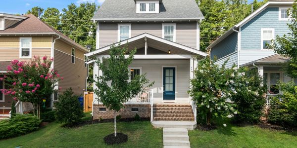 White two-story house with a blue door and front porch.