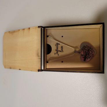 Heart-shaped pendant necklace in a wooden box with "Unfinitely love" inscription.