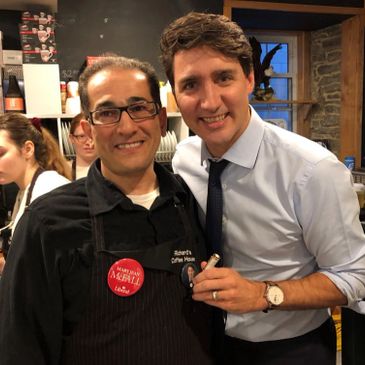 Sam Rawas, owner of Richard's Coffee house, standing next to Prime Minister Justin Trudeau.