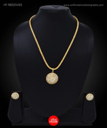 gold necklace with pendent display on a black mannequin stand