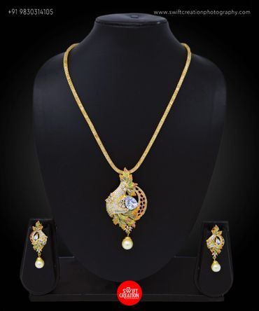 necklace and ear rings display on a black mannequin stand