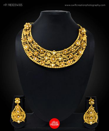 junk jewellery display on a black mannequin stand