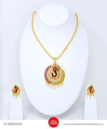 ganesh ji golden jewelry display on a white mannequin stand