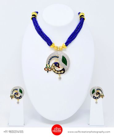 blue peacock necklace set display on a white mannequin stand