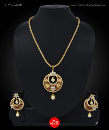 golden jewellery display on a black mannequin stand