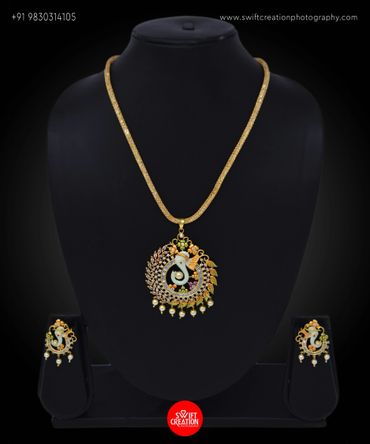ganesh pendent necklace and ear rings set display on a black mannequin stand