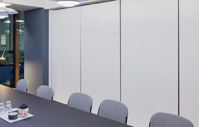 Commercial roller shades installed behind a conference table by West Coast Vertical Components.