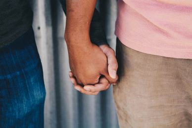 a couple holding each others hand