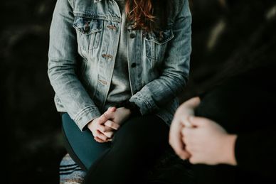 A couple sitting together holding their hands