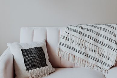 Therapist Counselling Sofa with white and black blanket and cushion