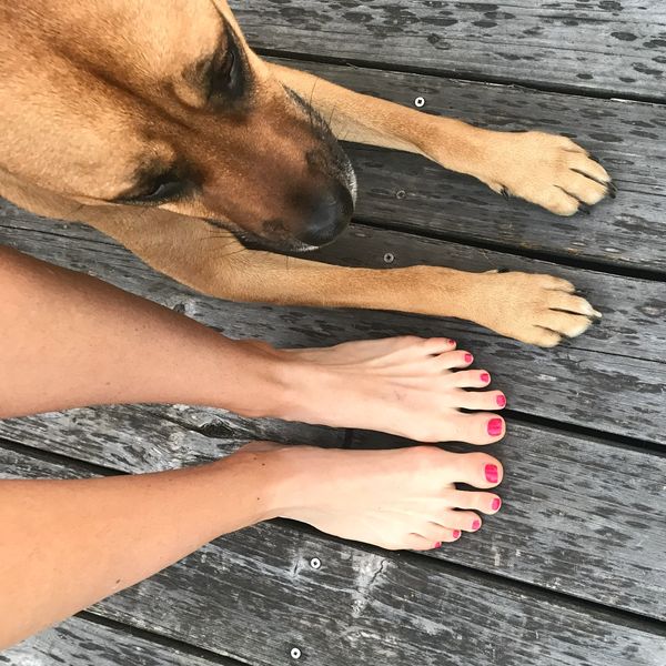 Klea and her rescue dog Cody comparing summer golf tans.