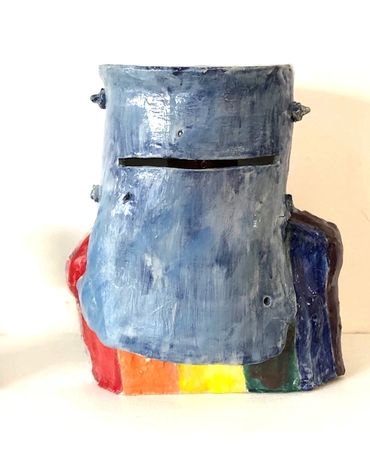 A figurative ceramic sculpture of Ned Kelly with a pride flag and trans flag verso