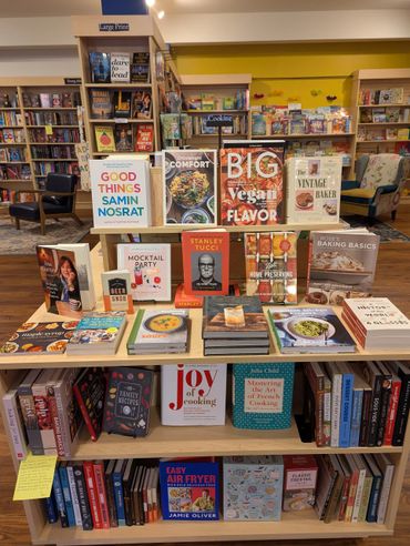 A bookstore display featuring a variety of colorful cookbooks and culinary guides.