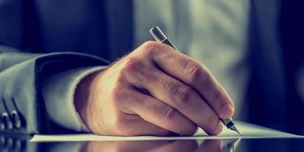 man writing a grant proposal
