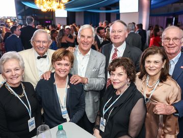 Group of smiling adults at a formal event.