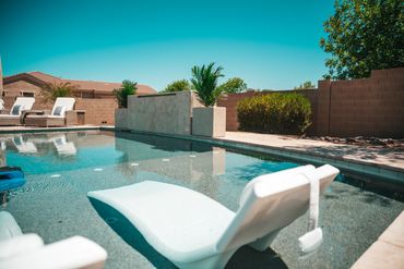 Outdoor kitchen with water feature in Arizona backyard