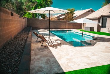 Retaining wall with clean stone finish framing raised planting bed