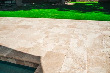 Close-up of new pool tile and coping with paver edge detail