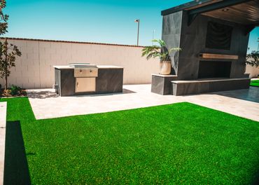 Backyard with cantilever shade structure and black tile over the built in bbq in Gilbert