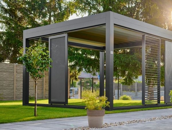 Modern outdoor gazebo with metal frame and gray panels.
