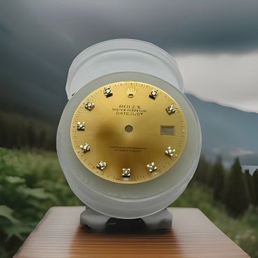 Gold watch dial on stand.