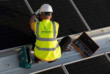 engineer wearing helmet and vest fixing solar pv panel