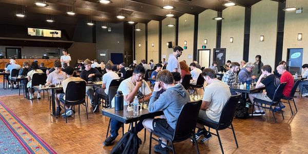 People playing chess in a large room.