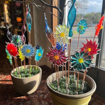 blown glass flowers and feathers in pots