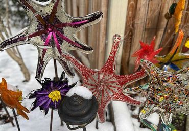 blown glass outdoor flowers in the snow