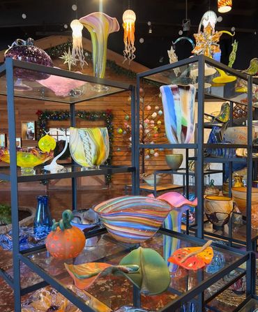 assortment of blown glass bowls, vases, leafs, lighting, etc