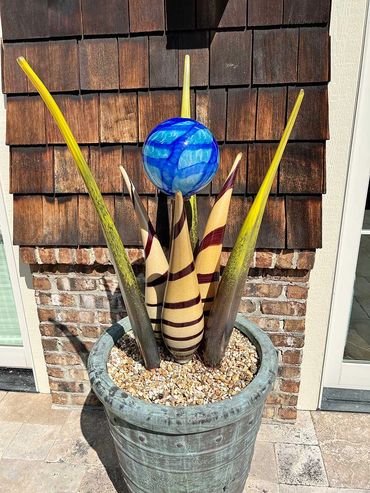 outdoor blown glass yard sculpture, wired and lit.