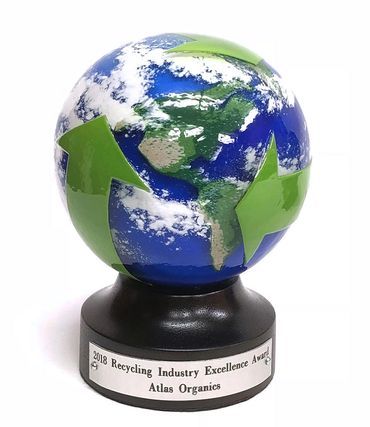 blown glass earth award on round wood base